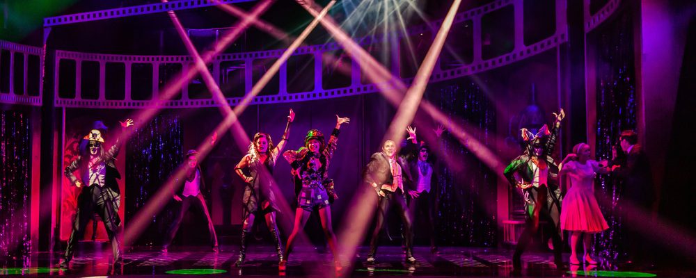 Seven gothic characters performing onstage