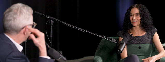 Jasmim Vardimon and Sir Alistair Spalding sit in lounge chairs in conversation with each other