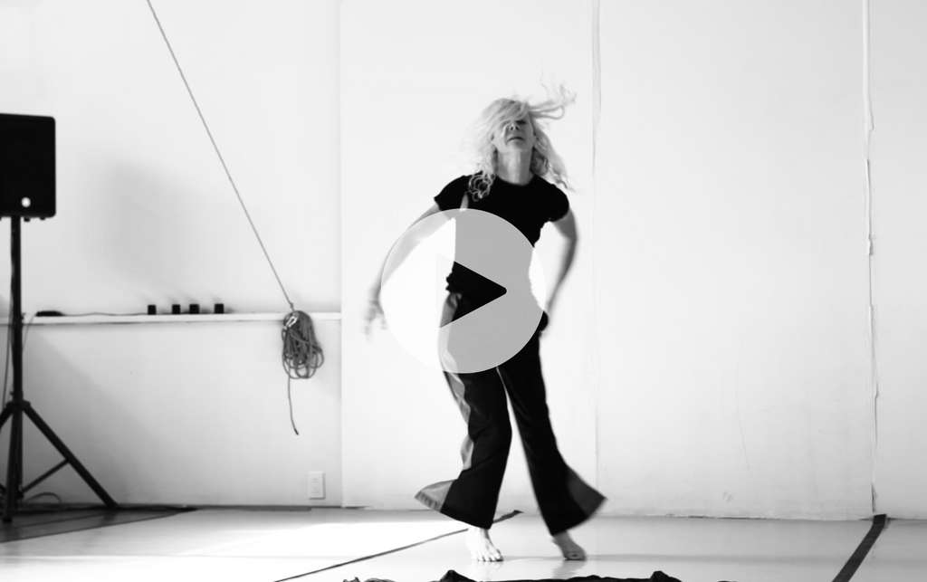 A black and white shot of Louise Lecavalier dancing